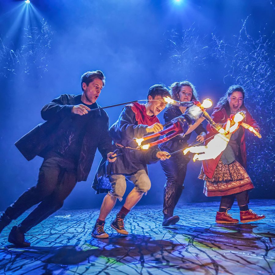 Domonic Ramsden and Keir Oglivy (Boy), operating two illuminated stick puppets, as Aimee McGolderick and Millie Hikasa (Lettie) look on, laughing