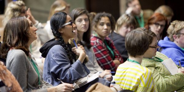 A group of people sat down asking questions at the Drama Teacher Conference