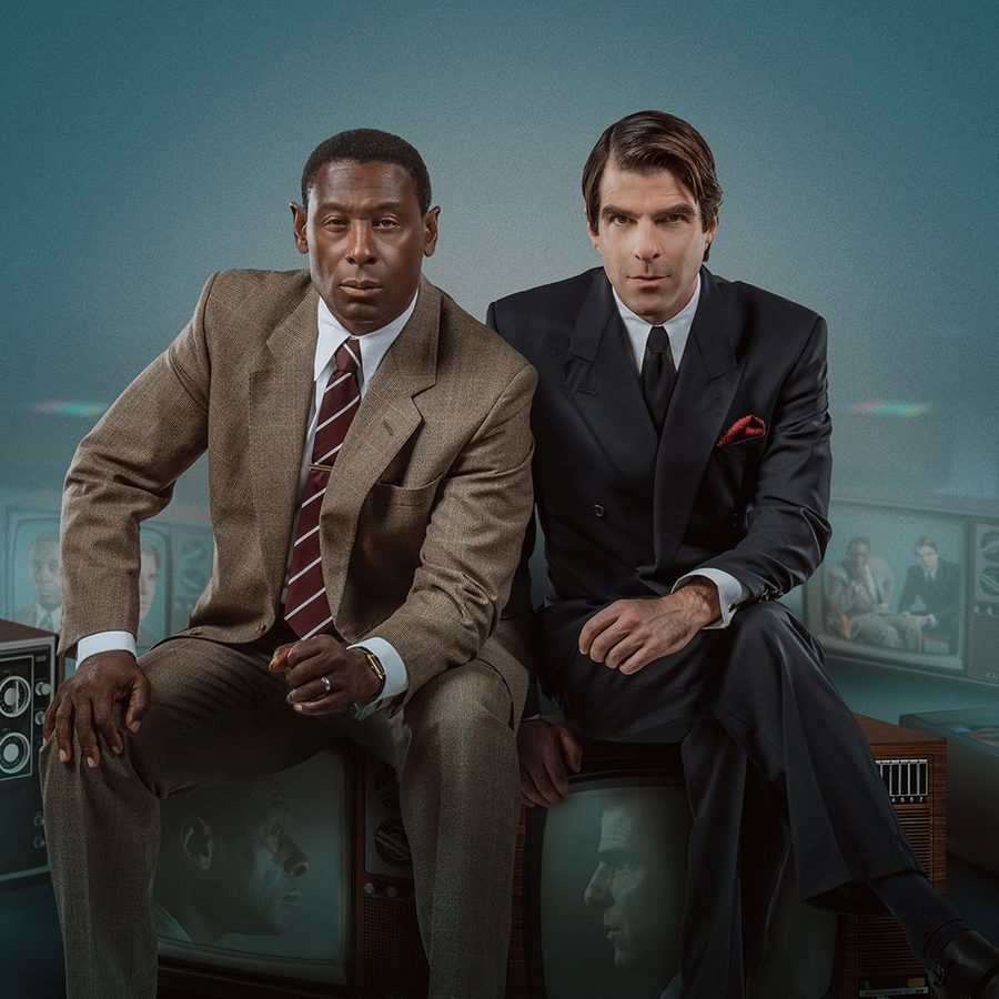 David Harewood and Zachary Quinto, dressed in suits and ties, sat side-by-side staring out at the camera