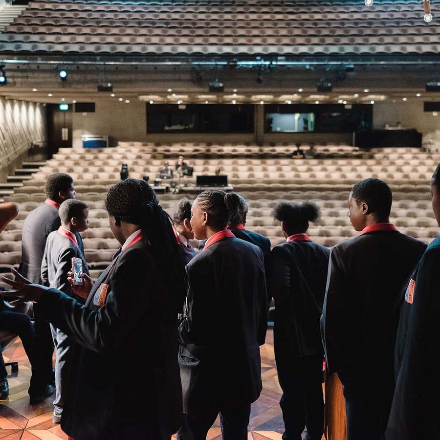 LearnExplorelanding-Creative-Choices-2019-2000x1000 A group of students walking through a backdoor onto the Lyttelton Stage at the National Theatre