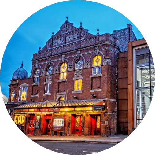 The front of the Theatre Royal Wakefiled building, a red-brick facade with a glass canopy projecting over the entrance.