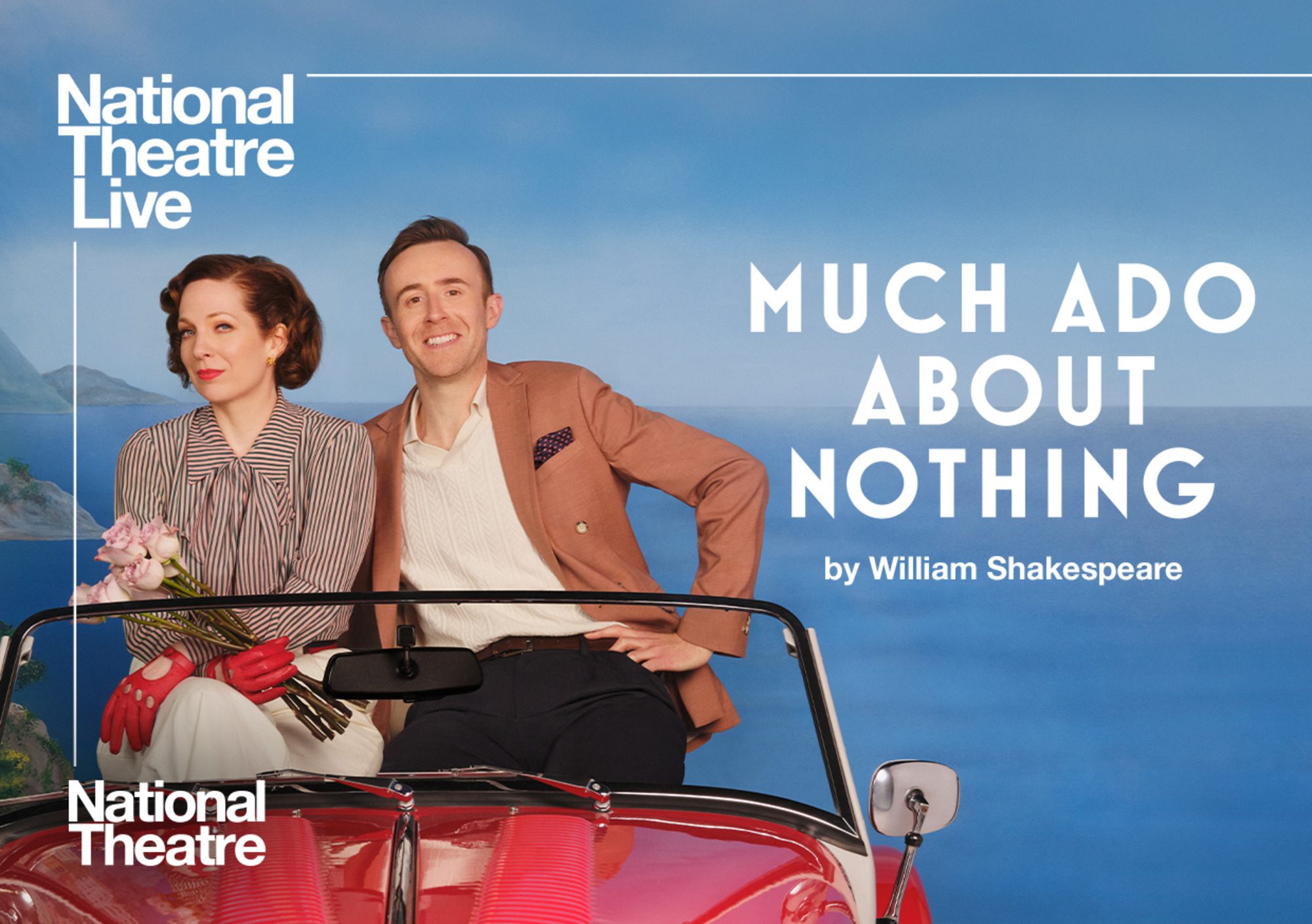 Two people sit on a red car against a backdrop of the ocean.