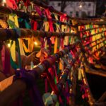 The wooden structure of the galley is covered in colourful ribbons. It is dark and the ribbons are lit from behind.