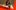 A man with a beard wearing a cream sweater sits with his hand resting on his face. The name 