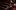NTGDS_NF_Connections 2025_Digital_A4 Landscape_RGB_Clean_2000x1000 Six people sit scattered across mostly empty red theater seats, wearing casual clothes in various colors. They appear relaxed, some with legs up on the seats, looking toward the camera.
